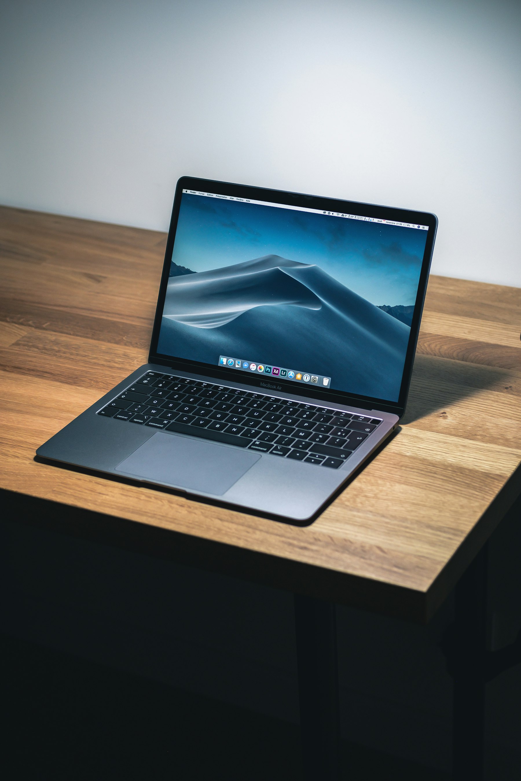 A laptop open on a wooden desk